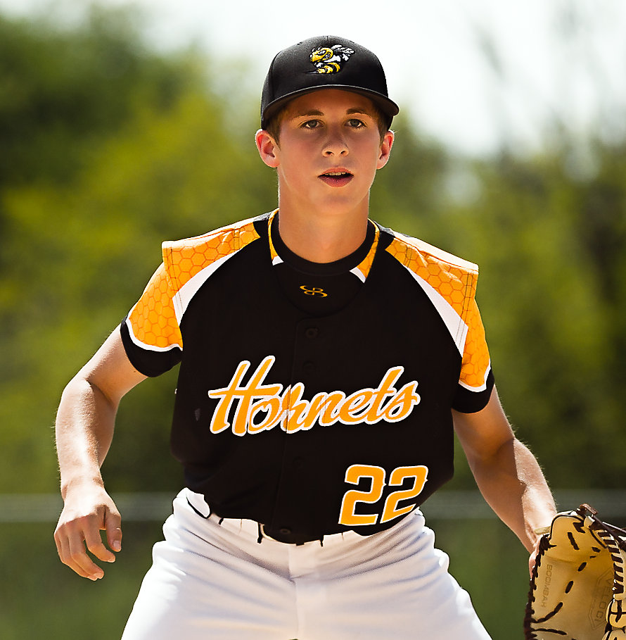 A baseball player in a black, yellow and white jersey