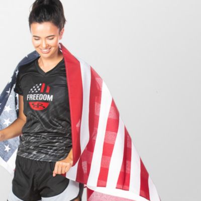 A girl with an American flag draped over her shoulders