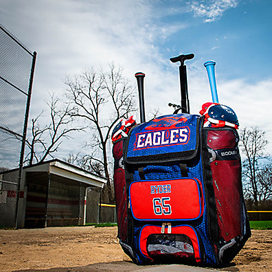 A blue and red custom bat bag filled with baseball gear