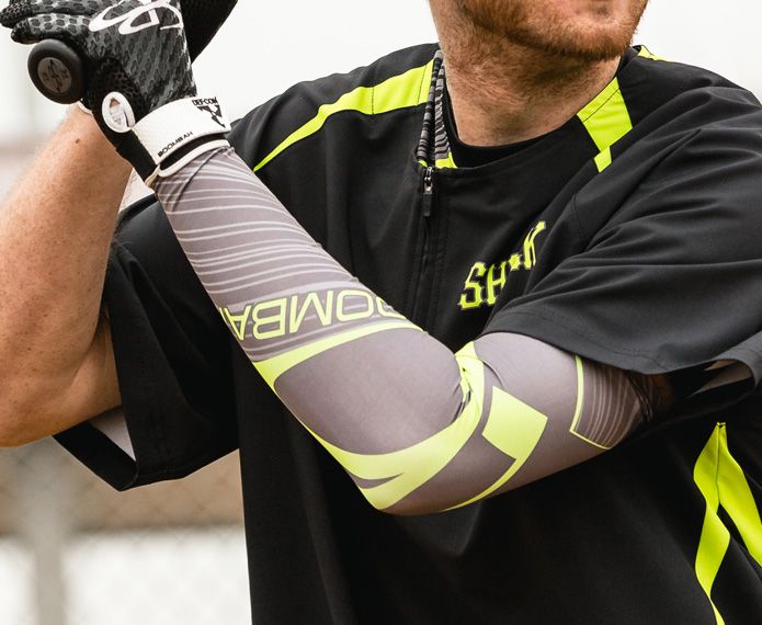Batter wearing a black and neon shirt and a grey and neon branded arm sleeve