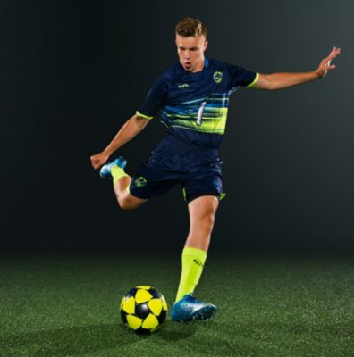 man playing soccer in custom soccer uniforms